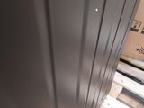 a metal door that is open on a wooden floor
