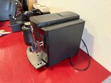 a coffee machine sitting on a red counter in a room