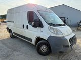 a white van that is parked in the dirt