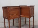 pair of wooden bedside tables with drawers on top of them