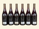 six bottles of red wine are lined up in a row