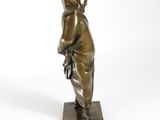 bronze statue of a boy with a book in his hands