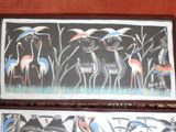 two paintings on the wall of a room with birds on them