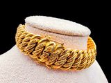 a close up of a gold bracelet on a mannequin mannequin
