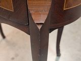 a close up of a wooden table with a drawer on it