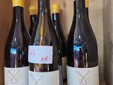 several bottles of wine are lined up in a wooden box