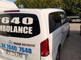 a van that is parked in a lot with other vehicles