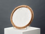 white marble plate with a rope around the edge on a pedestal