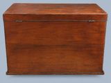 an old wooden box with a lid on a gray background