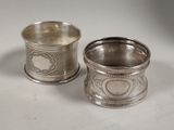 deux tasses en argent ornées de motifs, posées sur une surface blanche
