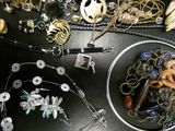 a bowl full of assorted jewelry on a table