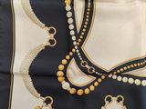 an image of a black and white scarf with pearls on it