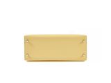 a yellow leather wallet with a metal plate on the front