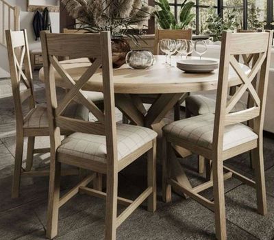 a wooden table with four chairs and a bowl on it