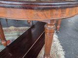 a wooden table with a bench underneath it in a room