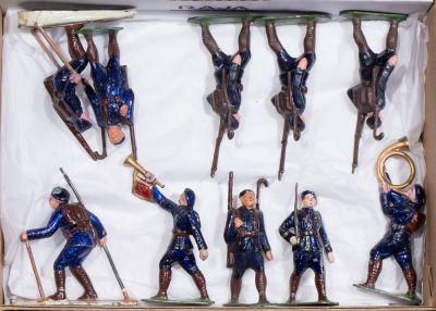 six figurines of men in blue uniforms in a box