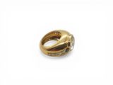 a close up of a gold ring with diamonds on a white background