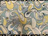 an image of a blue, yellow, and black rug with octopuses on it