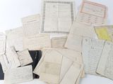 many old papers are piled on top of each other