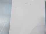 a piece of paper sitting on top of a toilet