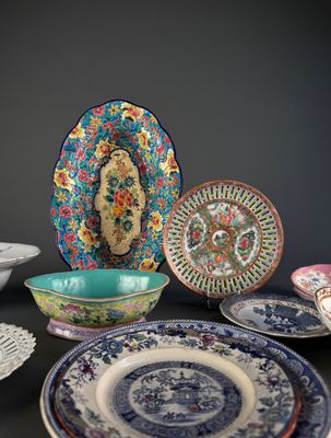 many plates and bowls sitting on a black table