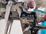 a close up of a tattoo machine with a red light on it