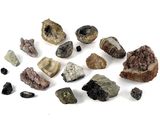 several different types of rocks and stones on a white surface