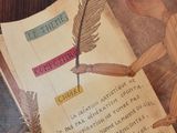 a picture of a book on a table with a pen and inkwell