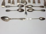 a lot of silver spoons and spoon spoons on a table