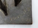 a metal sculpture of a horse on a white surface