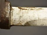 a close up of a knife with rust on it