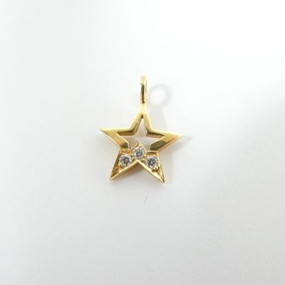 a small gold star charm with a diamond in the center
