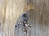 a key that is sitting on a table with a bunch of keys