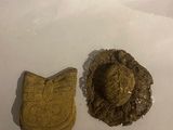 a cookie and a cookie cutter sitting on a piece of paper