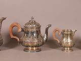 five pieces of silver tea and coffee set on a table