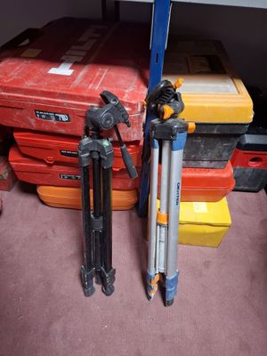 two tripods and a camera on the floor in a room