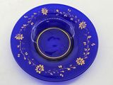 an image of a blue plate with gold flowers on it
