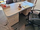 a desk that has a cup of coffee and a cell phone on it