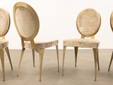 three chairs in a row with a white wall in the background