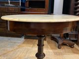 a wooden table with a marble top on a wooden floor