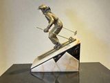 statue of a skier on a marble base on a black table