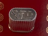 a silver container with a clock on it on a red surface