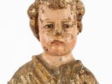 an old wooden statue of a woman holding a flower in her hand