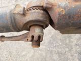 a rusted pipe that has a rusted nut attached to it