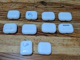 six white electronic devices sitting on a wooden table