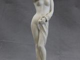 statue of a woman with a hat on her head and hands on her hips