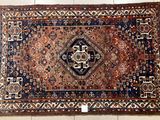 an oriental rug on the floor with a white tile floor