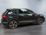 the rear end of a black volkswagen suv parked in a garage