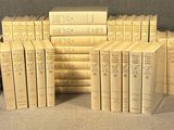 many books stacked on top of each other on a table