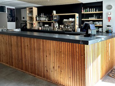 a picture of a bar with a lot of bottles on the counter